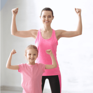 mom and young daughter with arms flexed strong