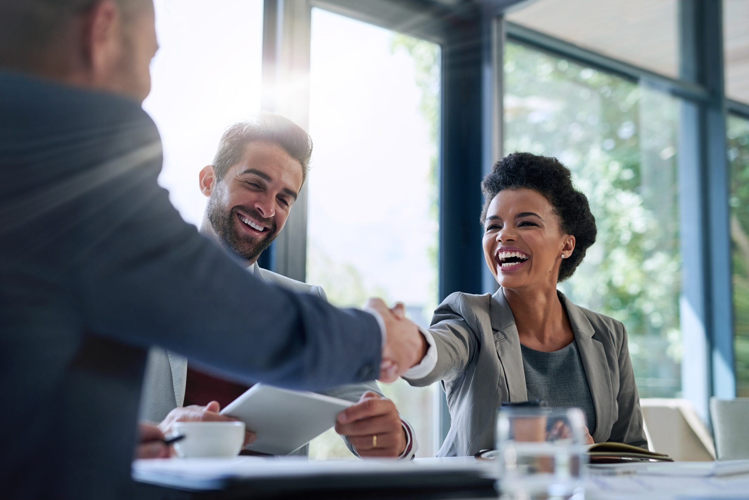 Meeting,,Partnership,And,Business,People,Shaking,Hands,In,The,Office Employer shaking hands with a candidate during a successful job interview, symbolizing how Boulo helps companies hire top talent with confidence and cultural alignment.